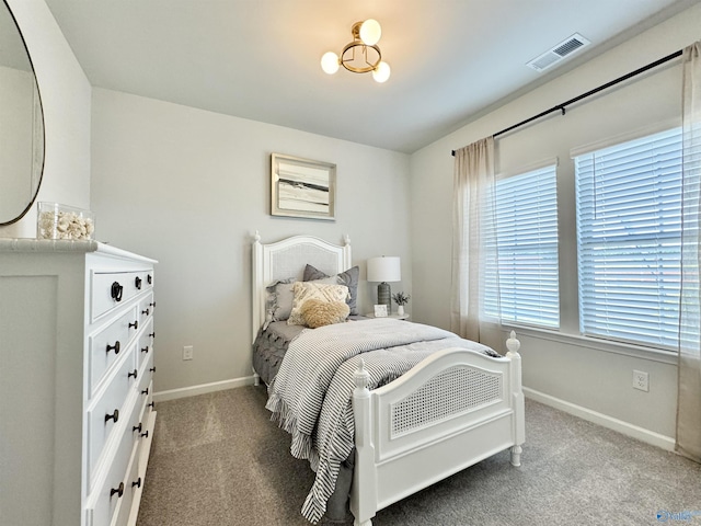 carpeted bedroom with baseboards and visible vents