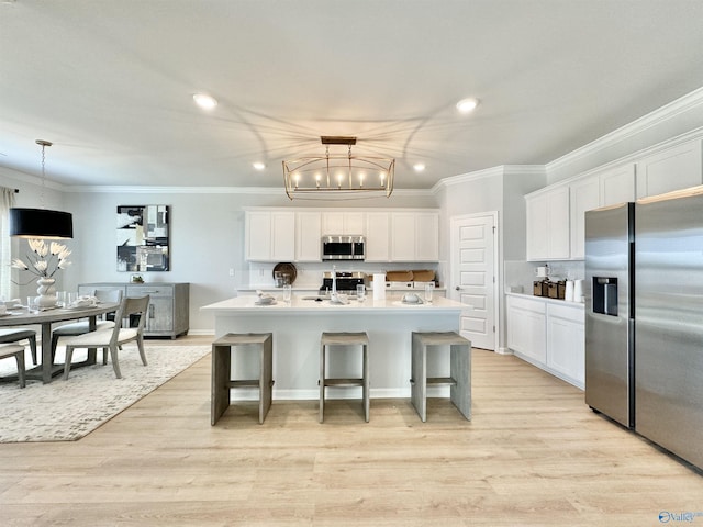 kitchen featuring light wood-style flooring, white cabinets, stainless steel appliances, and light countertops