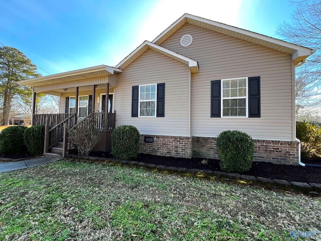 view of front of house featuring covered porch and crawl space