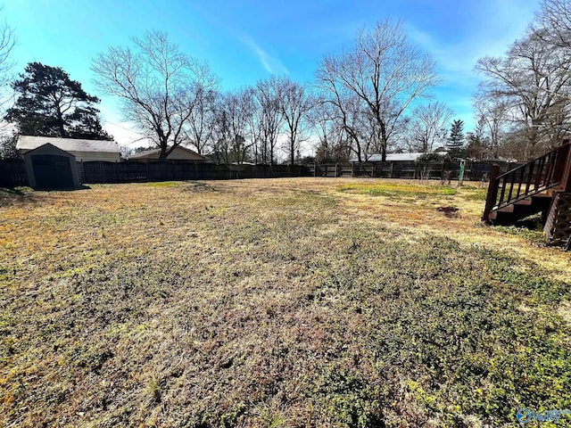 view of yard featuring an outbuilding and fence