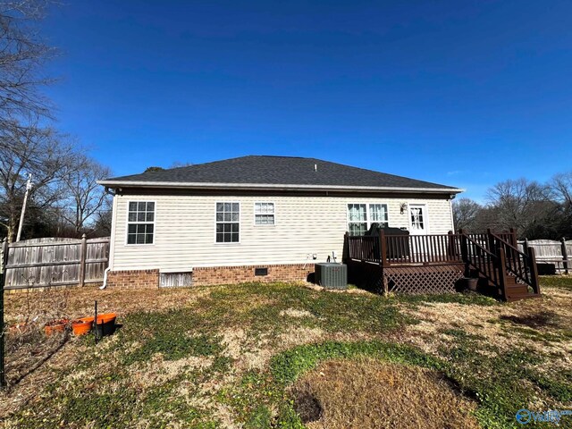 rear view of property featuring crawl space, fence, cooling unit, and a wooden deck