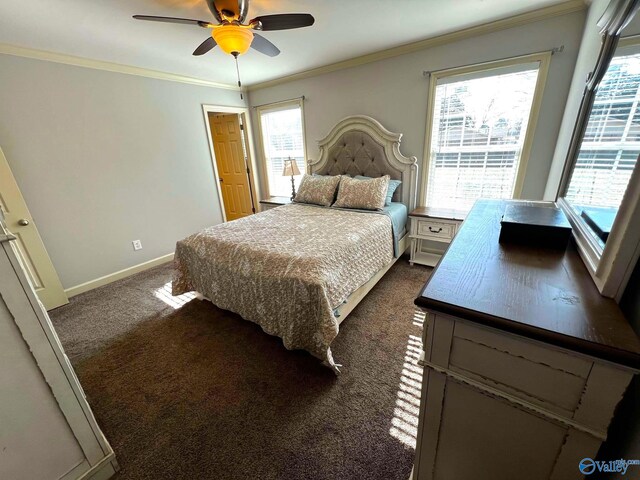 bedroom with baseboards, dark colored carpet, ceiling fan, and crown molding