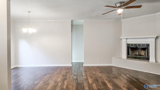 unfurnished living room with a fireplace with raised hearth, ornamental molding, and dark wood finished floors