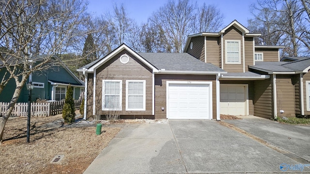 view of front of house featuring an attached garage, driveway, fence, and roof with shingles