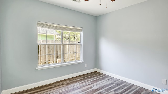 spare room with ceiling fan, baseboards, and wood finished floors