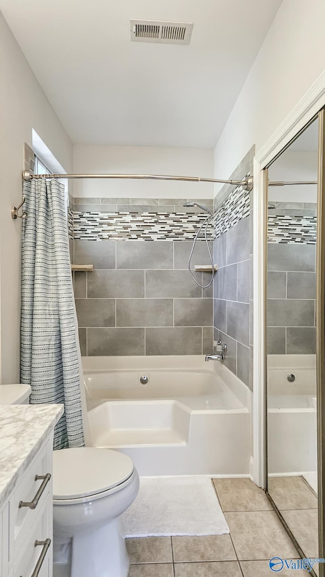 bathroom with toilet, shower / tub combo, vanity, visible vents, and tile patterned floors