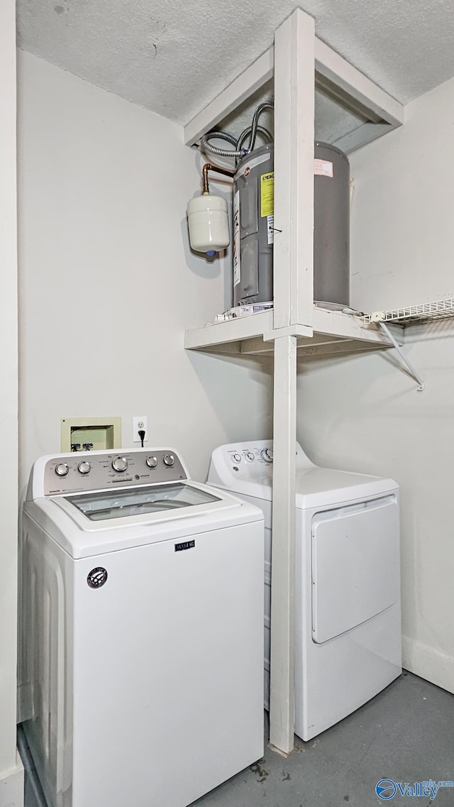 laundry room with a textured ceiling, laundry area, and washing machine and dryer