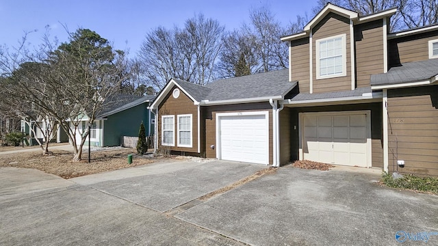 view of front of house with driveway and a shingled roof