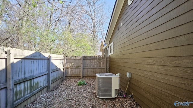 view of yard with a fenced backyard and central air condition unit