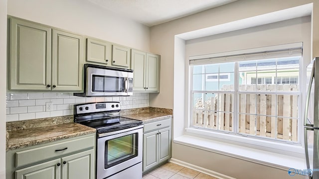 kitchen featuring appliances with stainless steel finishes, backsplash, and light tile patterned floors