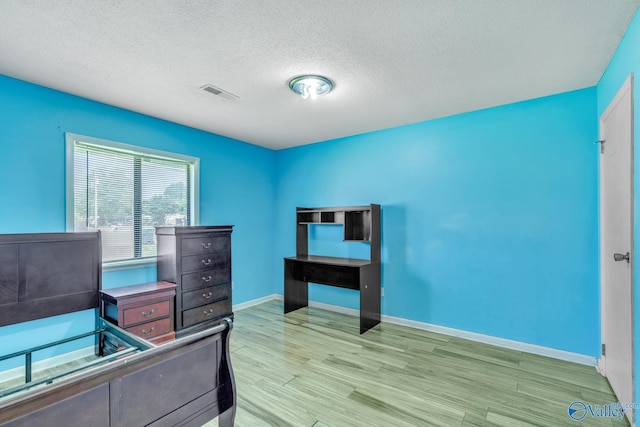 3104 Sandlin Rd SW, Decatur, AL 35603 - bedroom with wood finished floors, a textured ceiling, and baseboards