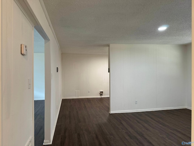 unfurnished room with dark hardwood / wood-style floors and a textured ceiling