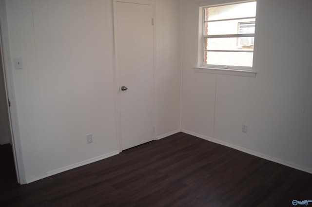 spare room featuring dark wood-type flooring