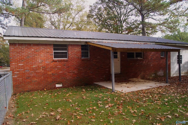 rear view of property with a patio and a yard