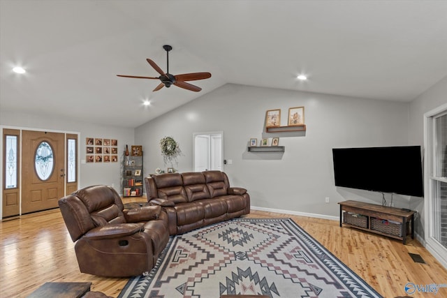 living room featuring ceiling fan, light hardwood / wood-style floors, and lofted ceiling