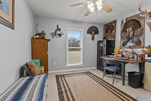 carpeted office featuring ceiling fan