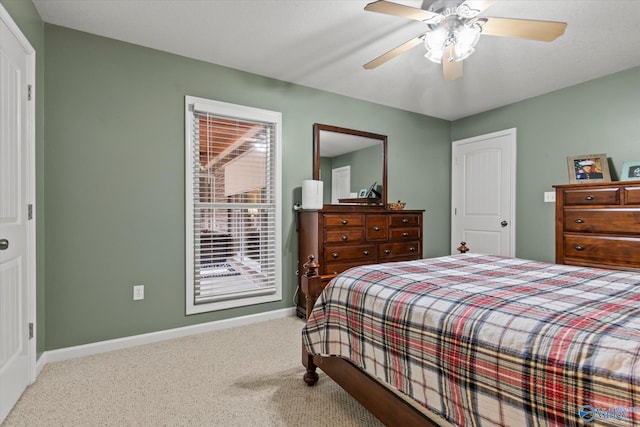 bedroom with ceiling fan and light carpet