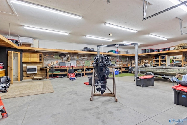 garage featuring heating unit and a workshop area