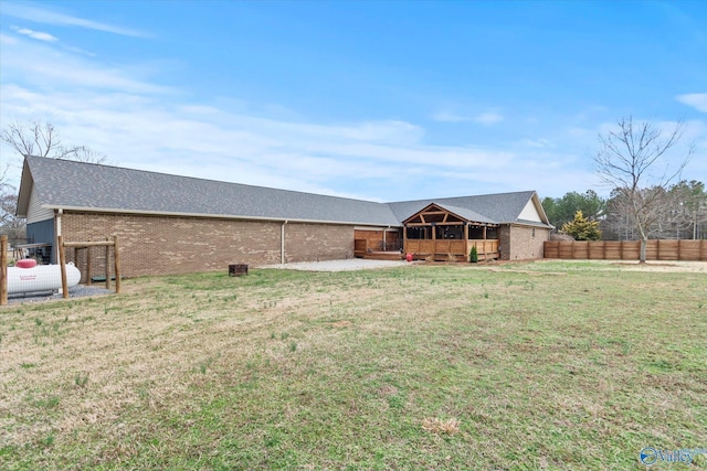 back of property with a yard and a patio area