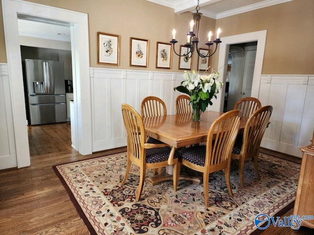 dining room with an inviting chandelier, crown molding, and dark wood-type flooring