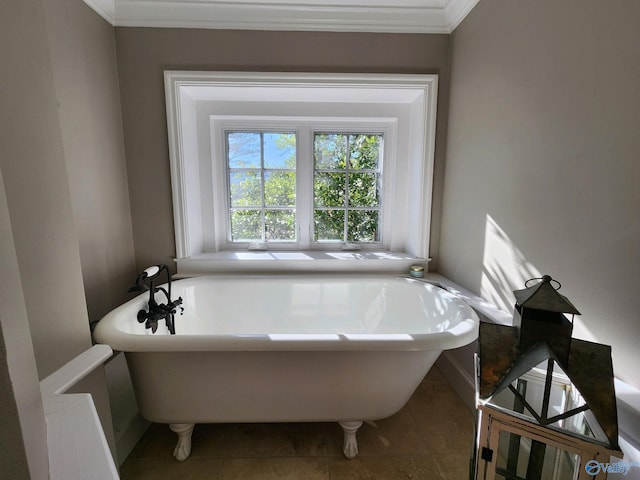 bathroom with a washtub, tile patterned flooring, and ornamental molding