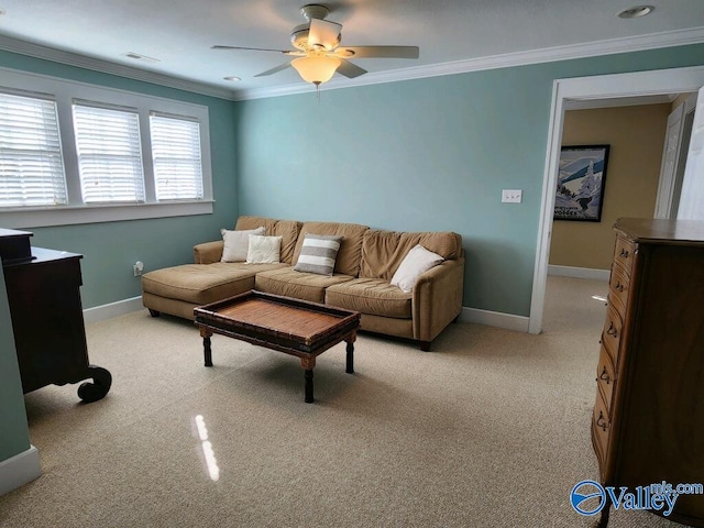 carpeted living room featuring ornamental molding and ceiling fan