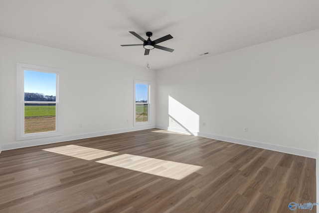 empty room with plenty of natural light and baseboards