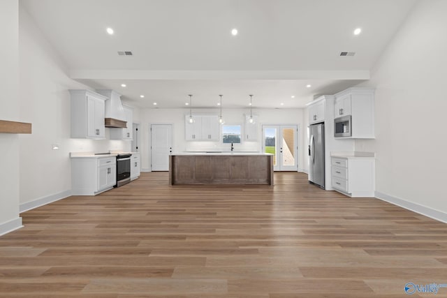 kitchen with light countertops, white cabinetry, and appliances with stainless steel finishes