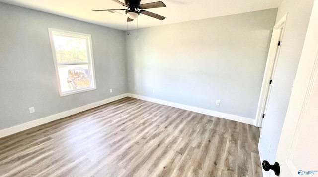 spare room with light wood-type flooring and ceiling fan