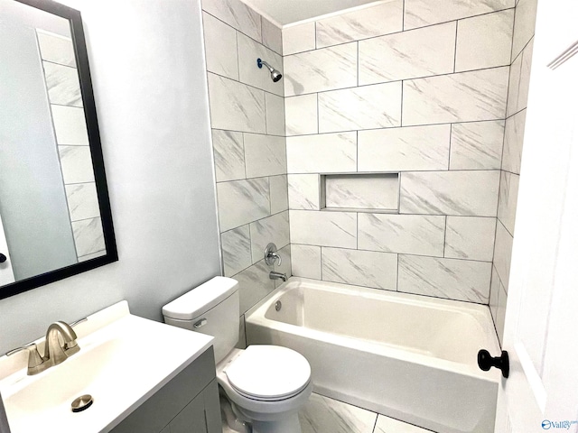 full bathroom with toilet, vanity, and tiled shower / bath