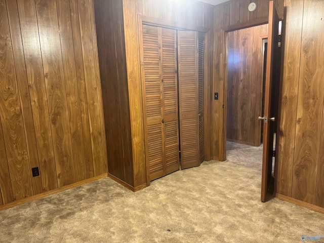 interior space featuring light carpet and wood walls