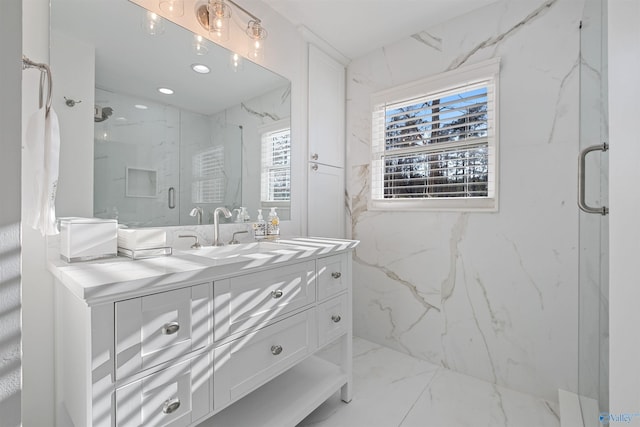 bathroom featuring a marble finish shower, marble finish floor, and vanity