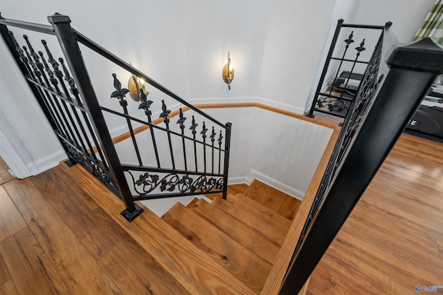 stairs with baseboards and wood-type flooring