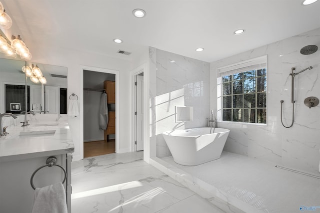 full bath with visible vents, a freestanding tub, marble finish floor, recessed lighting, and a marble finish shower