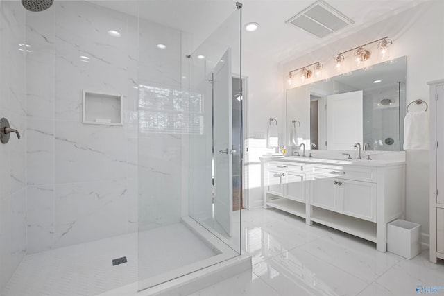 bathroom with a marble finish shower, visible vents, double vanity, marble finish floor, and a sink