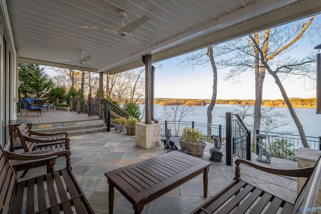 view of patio / terrace featuring ceiling fan and a water view