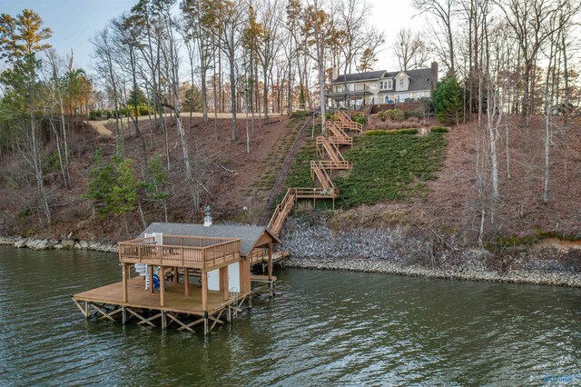 view of dock with stairway and a deck with water view