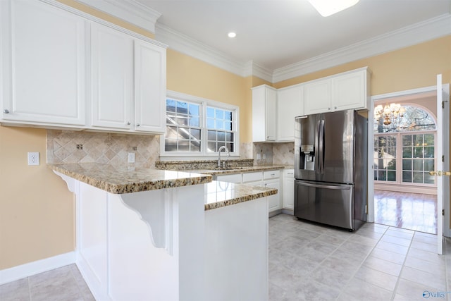 kitchen with white cabinetry, light stone counters, and stainless steel refrigerator with ice dispenser