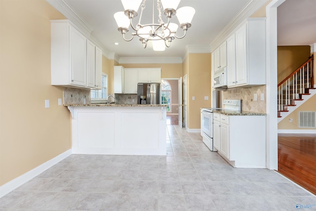 kitchen with white appliances, stone countertops, visible vents, baseboards, and crown molding