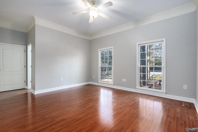 spare room featuring a wealth of natural light, a ceiling fan, hardwood / wood-style flooring, and baseboards