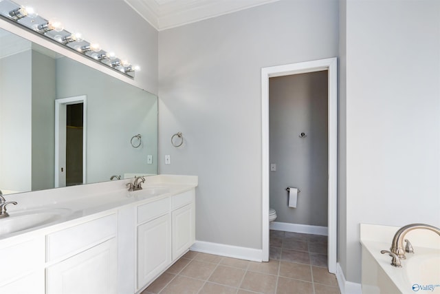 full bathroom with double vanity, a sink, toilet, and tile patterned floors