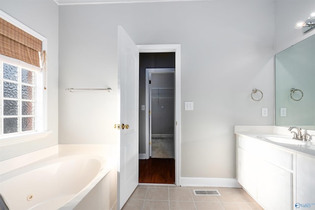 full bath with a garden tub, visible vents, vanity, tile patterned flooring, and baseboards