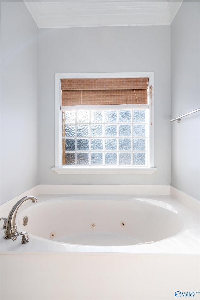 full bathroom with a whirlpool tub and ornamental molding