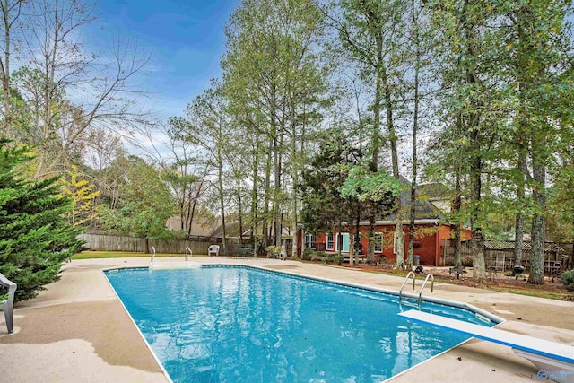 view of swimming pool with a patio area, fence, and a fenced in pool