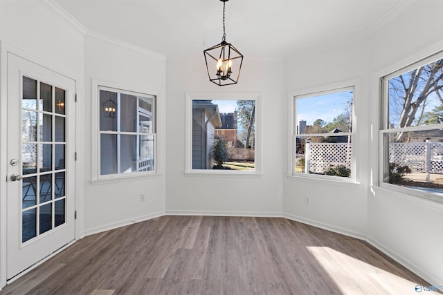 unfurnished dining area featuring ornamental molding, plenty of natural light, and dark hardwood / wood-style floors