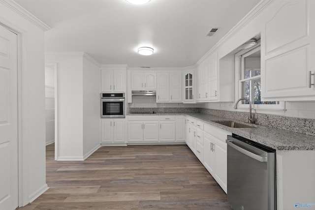 kitchen featuring sink, stone counters, white cabinets, and appliances with stainless steel finishes