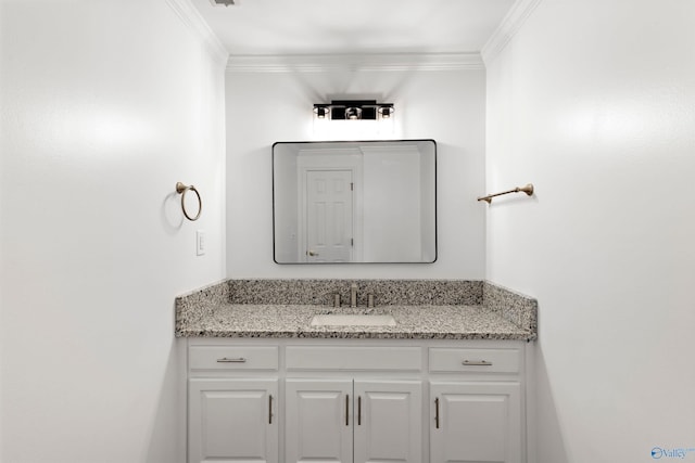 bathroom with ornamental molding and vanity