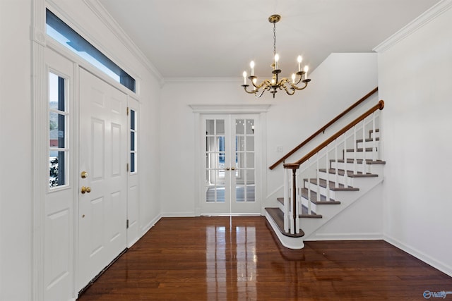 entryway with french doors, a notable chandelier, dark hardwood / wood-style floors, and crown molding