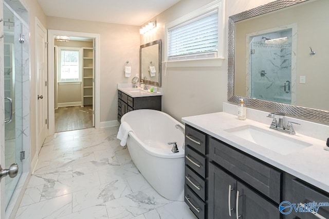 bathroom with vanity, wood-type flooring, and shower with separate bathtub