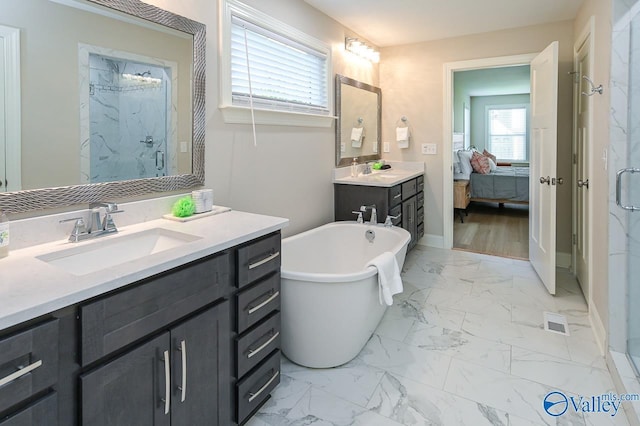 bathroom featuring vanity and independent shower and bath